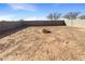 Large backyard with block wall fencing and a central fire pit feature at 13481 W Buckskin Trl, Peoria, AZ 85383