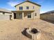 Large backyard with a stone firepit and covered patio at 13481 W Buckskin Trl, Peoria, AZ 85383