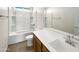 Bright bathroom features a vanity with white countertop, wooden cabinets, and a shower-tub combination at 13481 W Buckskin Trl, Peoria, AZ 85383