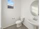 A well-lit half bathroom with a pedestal sink and tiled flooring at 13481 W Buckskin Trl, Peoria, AZ 85383