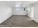 A carpeted bedroom featuring plenty of natural light from two windows at 13481 W Buckskin Trl, Peoria, AZ 85383