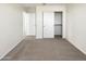 A bright, carpeted bedroom featuring a closet with sliding doors at 13481 W Buckskin Trl, Peoria, AZ 85383