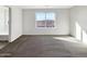 Spacious bedroom with neutral carpet, bright windows offering pleasant views at 13481 W Buckskin Trl, Peoria, AZ 85383