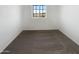 Neutral bedroom with carpeted floor and bright window at 13481 W Buckskin Trl, Peoria, AZ 85383