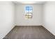 A bright, carpeted bedroom featuring a large window at 13481 W Buckskin Trl, Peoria, AZ 85383