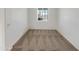 A cozy, carpeted bedroom with a window letting in natural light at 13481 W Buckskin Trl, Peoria, AZ 85383