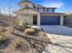 Charming two-story home with a blue garage door and low-maintenance landscaping at 13481 W Buckskin Trl, Peoria, AZ 85383
