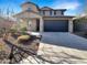 Beautiful two-story home featuring a blue garage door and attractive landscaping at 13481 W Buckskin Trl, Peoria, AZ 85383