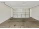 An empty garage with a sealed concrete floor and an insulated garage door at 13481 W Buckskin Trl, Peoria, AZ 85383