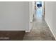 Hallway showcasing tiled floors connecting to carpeted area at 13481 W Buckskin Trl, Peoria, AZ 85383