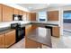 A modern kitchen with stainless steel appliances and an island at 13481 W Buckskin Trl, Peoria, AZ 85383