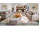 Bright living room featuring stylish couches, modern decor, and view to the kitchen at 13481 W Buckskin Trl, Peoria, AZ 85383