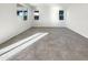 A spacious living room featuring tiled floors and multiple windows at 13481 W Buckskin Trl, Peoria, AZ 85383