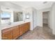 Large bathroom featuring double sinks, wood cabinets, and a separate shower room at 13481 W Buckskin Trl, Peoria, AZ 85383