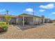 View of a covered patio extending into a spacious backyard featuring desert landscaping at 140 W University Dr, Mesa, AZ 85201