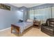 Cozy bedroom with a blue accent wall, comfortable single bed and cozy armchair at 140 W University Dr, Mesa, AZ 85201