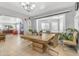 Dining room with a large wood table, views into the kitchen and living area at 140 W University Dr, Mesa, AZ 85201