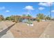 Street view of a charming, single-story residential building with a blue brick facade, xeriscaping, and well-maintained landscaping at 140 W University Dr, Mesa, AZ 85201