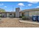 A one-story home showcasing a low-maintenance desert landscape and a painted brick exterior at 140 W University Dr, Mesa, AZ 85201