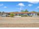 Charming single-story home featuring a beautiful blue exterior, a well-manicured front yard, and a classic front door at 140 W University Dr, Mesa, AZ 85201