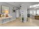 Bright hallway showcasing tiled floors, a welcoming desk, and an open view into the dining and living areas at 140 W University Dr, Mesa, AZ 85201