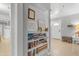 Bright and airy hallway boasts a well-stocked bookshelf and open access to other inviting living spaces at 140 W University Dr, Mesa, AZ 85201