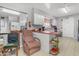 Spacious kitchen featuring white cabinets, red countertops, and convenient seating area at 140 W University Dr, Mesa, AZ 85201