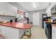 Bright kitchen featuring white cabinets, red countertops, and an exit door at 140 W University Dr, Mesa, AZ 85201