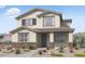 Charming two-story home with neutral paint, shuttered windows, brick accents, and tile roof at 14596 W Sand Hills Rd, Surprise, AZ 85387