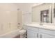 Bright bathroom featuring a shower-tub combo and a white single sink vanity at 1541 W Lynne Ln, Phoenix, AZ 85041