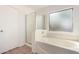 Bathroom featuring a tub and shower combination with glass doors and a clear window at 1541 W Lynne Ln, Phoenix, AZ 85041