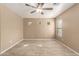 Bright bedroom with neutral walls, tile flooring, ceiling fan, and three small windows at 1541 W Lynne Ln, Phoenix, AZ 85041