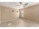 Bright bedroom with neutral walls, tile flooring, ceiling fan, and three small windows at 1541 W Lynne Ln, Phoenix, AZ 85041