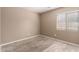 Bedroom featuring tiled floor, a window with horizontal blinds, and a neutral color palette at 1541 W Lynne Ln, Phoenix, AZ 85041