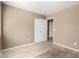 Bedroom featuring a closet with sliding doors, wood-look tiled flooring and neutral-colored walls at 1541 W Lynne Ln, Phoenix, AZ 85041