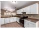 Bright open kitchen featuring stainless steel appliances, tiled floors and white cabinetry at 1541 W Lynne Ln, Phoenix, AZ 85041