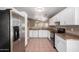 A spacious kitchen featuring stainless steel refrigerator, white cabinets and tile flooring at 1541 W Lynne Ln, Phoenix, AZ 85041