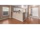 Open concept kitchen with white cabinets, hardwood floors, an eat-in bar and natural light at 1541 W Lynne Ln, Phoenix, AZ 85041