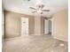 Spacious main bedroom boasts neutral walls, wood-look tile flooring, and a ceiling fan with a view to the bathroom at 1541 W Lynne Ln, Phoenix, AZ 85041