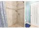 Shower featuring beige tiling, built-in niche, and a blue patterned shower curtain, creating a modern space at 1645 W Baseline Rd # 2176, Mesa, AZ 85202