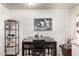 Dining area featuring a dark wood table, bar shelving and decorative artwork at 1645 W Baseline Rd # 2176, Mesa, AZ 85202