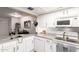 Bright kitchen featuring white cabinets, granite countertops, and modern appliances at 1645 W Baseline Rd # 2176, Mesa, AZ 85202