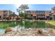 Scenic view of community pond and gazebo surrounded by mature trees and rock landscaping at 1645 W Baseline Rd # 2176, Mesa, AZ 85202
