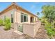 This backyard features a block wall, mature landscaping, and a view of palm trees at 16911 W Palm Ln, Goodyear, AZ 85395