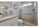 Well-lit bathroom with a glass-enclosed shower, modern fixtures, and neutral tile at 16911 W Palm Ln, Goodyear, AZ 85395