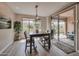 Bright dining room features a modern table, stylish lighting, and access to a covered patio at 16911 W Palm Ln, Goodyear, AZ 85395