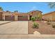 Beautiful single-story home with a three-car garage and desert landscaping for low maintenance at 16911 W Palm Ln, Goodyear, AZ 85395