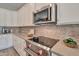 Close-up of the kitchen featuring a stainless steel oven, microwave, and custom backsplash at 16911 W Palm Ln, Goodyear, AZ 85395