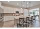 Modern kitchen boasts an island with seating, stainless steel appliances, and ample cabinet space at 16911 W Palm Ln, Goodyear, AZ 85395