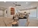 Comfortable living room with stylish furniture, a ceiling fan, and seamless flow into the kitchen at 16911 W Palm Ln, Goodyear, AZ 85395